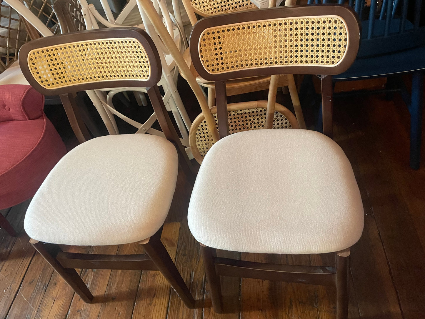 2 brown cane dining chairs w/ white cushion 🤎