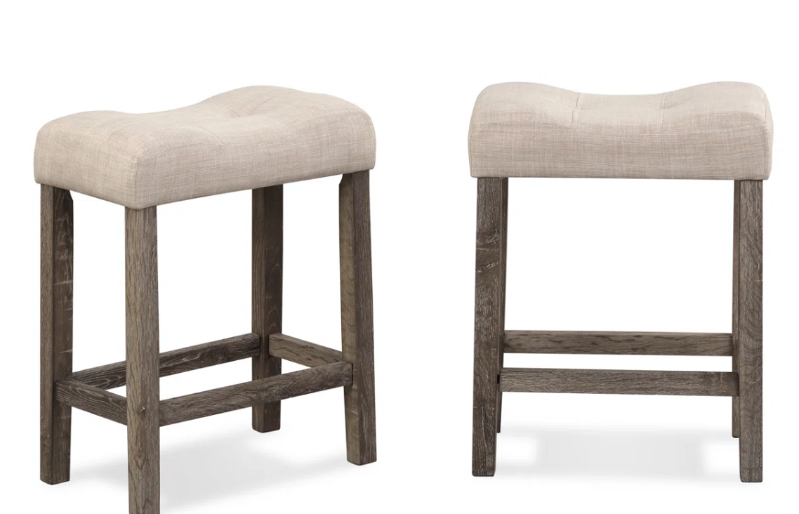 2 beige button-tufted counterheight saddle barstools 🍻