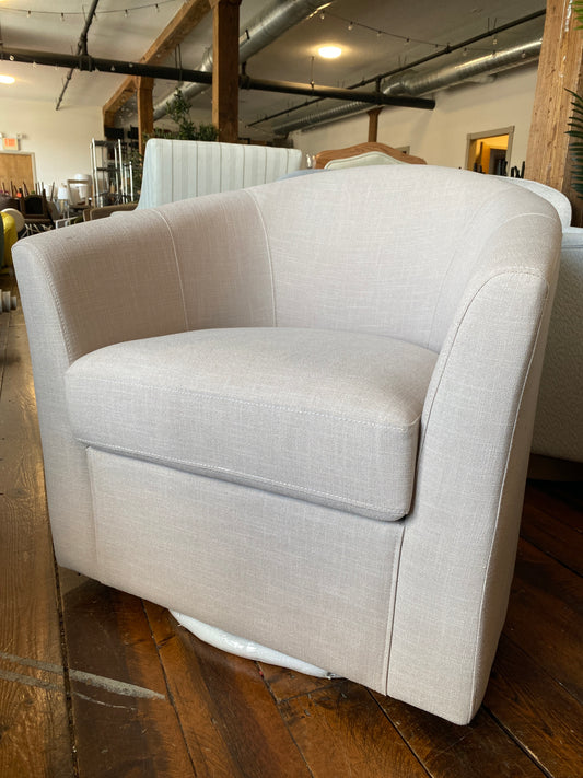 Grey linen upholstered swivel barrel chair 📖