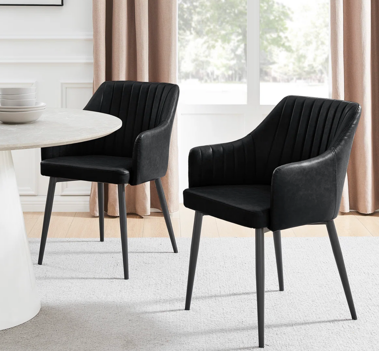2 black vegan leather dining chairs w/ tapered metal legs🍷